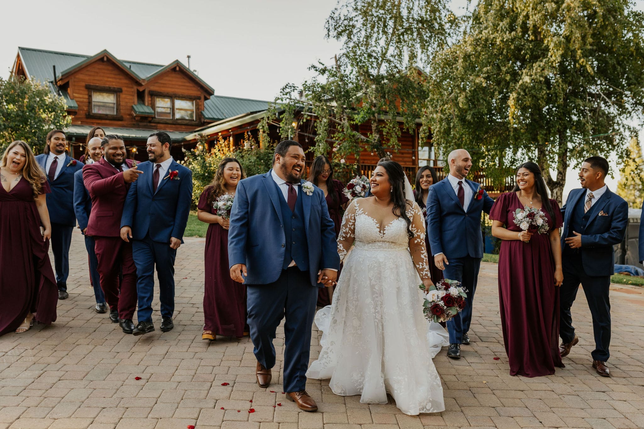 bride and groom walk with their wedding party after a ceremony at Lillaskog Lodge