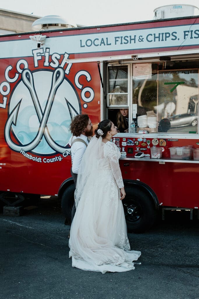 bride and groom stop at a taco truck for dinner